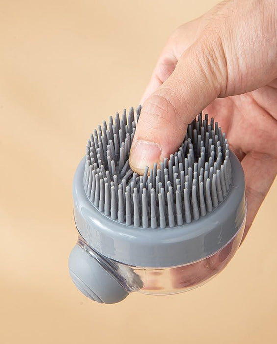 Gray silicone scrubbing brush with flexible bristles and a transparent liquid reservoir. Designed for bath and body cleansing, enabling deep exfoliation while dispensing soap or shampoo through the built-in container- 159845334888512362182