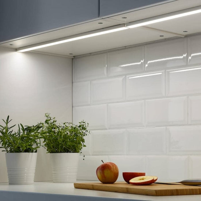 OMLOPP LED lights installed under a kitchen cabinet, providing white illumination-10430354