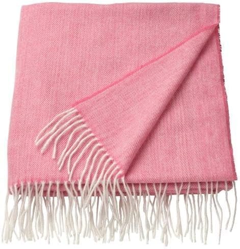 IKEA HOLMVI throw in soft pastel pink, measuring 120x160 cm (47x63"); features a lightweight woven texture with delicate white fringes lining the shorter edges. Folded neatly with one corner turned over to showcase the underside, the blanket presents a cozy and stylish design perfect for beds, sofas, or reading nooks. Ideal for adding warmth and a gentle pop of color to both modern and playful interiors – 00604689.