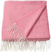 IKEA HOLMVI throw in soft pastel pink, measuring 120x160 cm (47x63"); features a lightweight woven texture with delicate white fringes lining the shorter edges. Folded neatly with one corner turned over to showcase the underside, the blanket presents a cozy and stylish design perfect for beds, sofas, or reading nooks. Ideal for adding warmth and a gentle pop of color to both modern and playful interiors – 00604689.