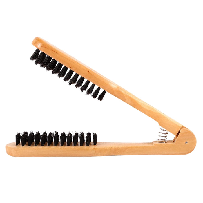 Wooden brush with black bristles on a white background