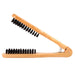 Wooden brush with black bristles on a white background