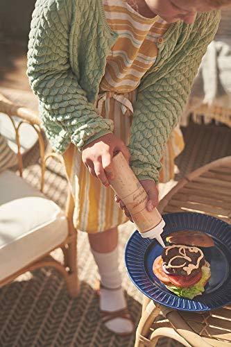 Person holding a plate with a burger outdoors