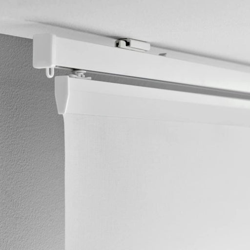IKEA VIDGA white ceiling fitting installed on ceiling with curtain track rail side angle view