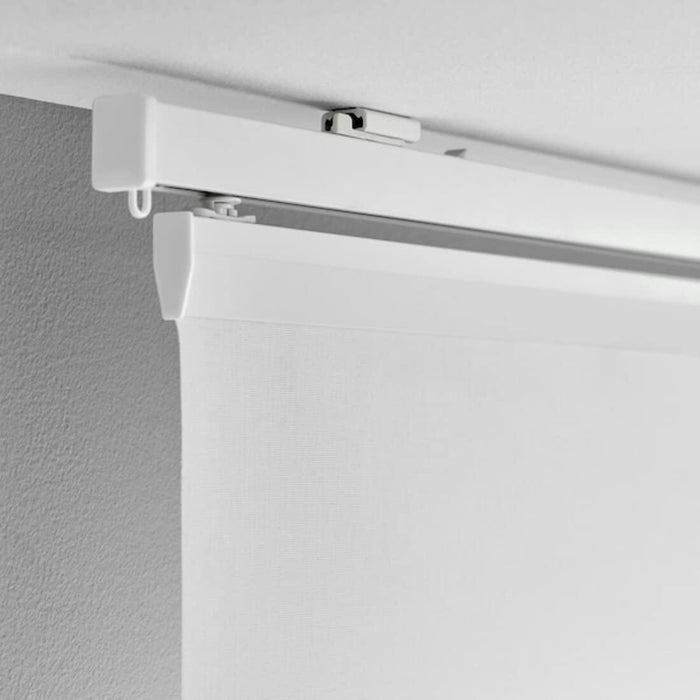 IKEA VIDGA white ceiling fitting installed on ceiling with curtain track rail side angle view