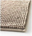 Close-up view of the IKEA TOFTBO pedestal mat in beige—shows a soft, plush surface made of tightly packed looped fibers for enhanced comfort and water absorption. The detailed texture emphasizes cushioning and coziness, ideal for placement around bathroom fixtures like toilets or sinks –50610268