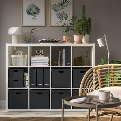 IKEA FJÄDERHARV storage box in anthracite—stacked inside a KALLAX shelf unit surrounded by books, décor, and lighting; front handle cut-out visible for easy access – 50596922.