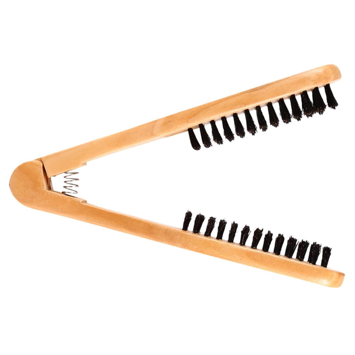 Wooden brush with black bristles on a white background
