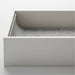 Close-up of KOMPLEMENT insert corner showing smooth grey felt lining and curved divider edges for delicate storage