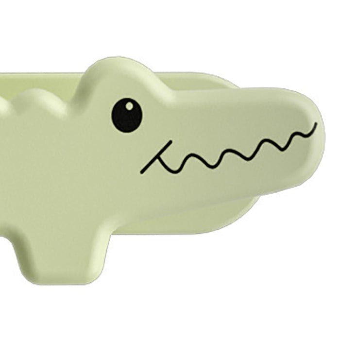 Light green alligator-shaped object on a white background