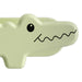 Light green alligator-shaped object on a white background