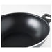 Close-up of the non-stick surface of the IKEA HEMLAGAD Wok, ensuring easy food release and simple cleanup