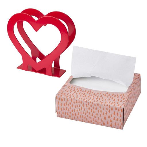 Red heart-shaped object next to a box of tissues on a white background