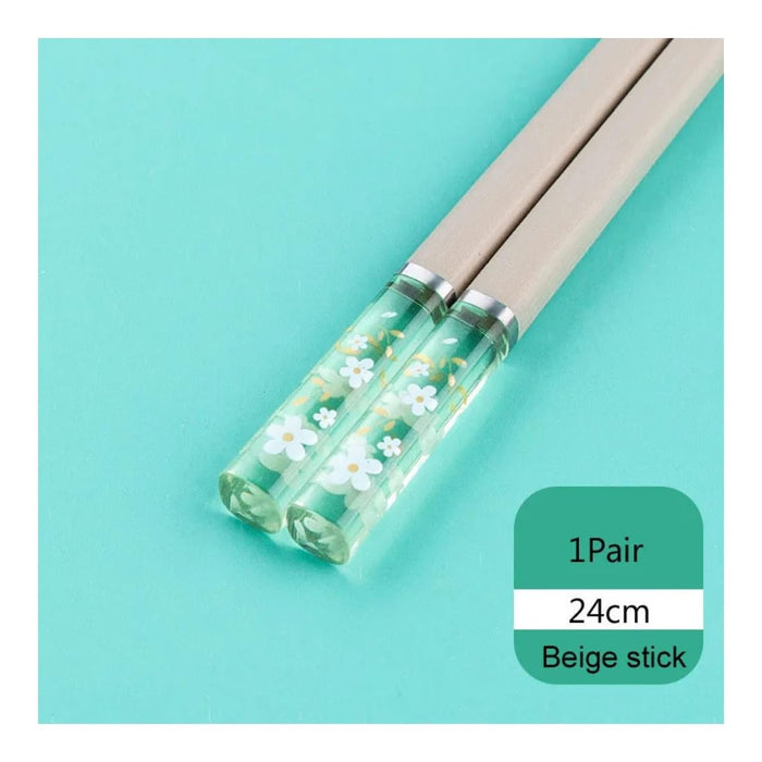 Chopsticks with floral design on a green background