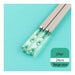 Chopsticks with floral design on a green background