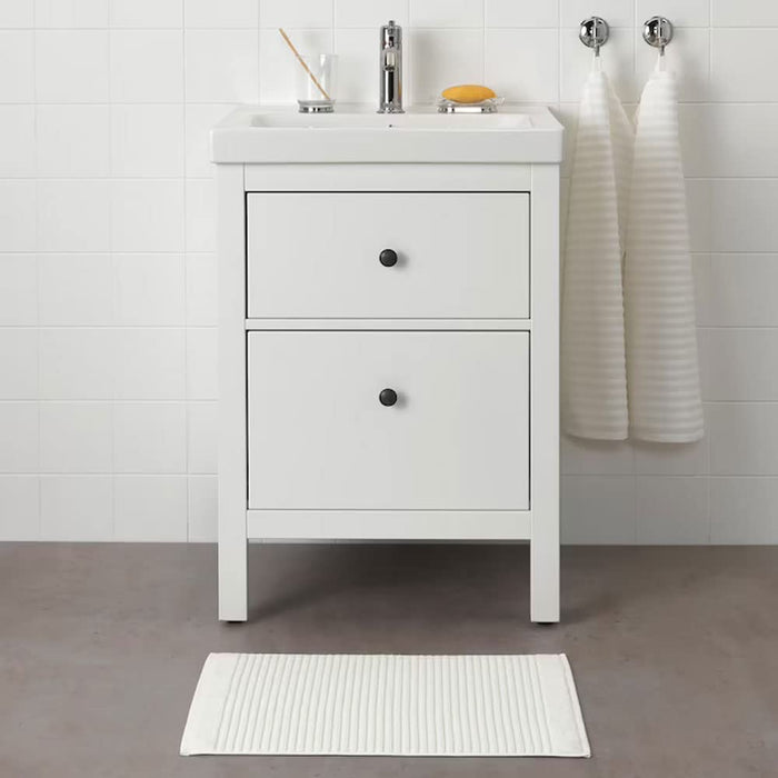 IKEA bath mat placed on a bathroom floor, featuring a soft and absorbent texture and a non-slip bottom for secure footing 90439322