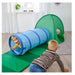 Children playing with a green and blue play tunnel in a room.
