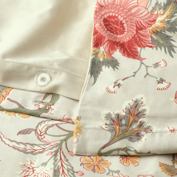 Floral patterned fabric with a button detail on a neutral background
