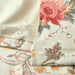 Floral patterned fabric with a button detail on a neutral background