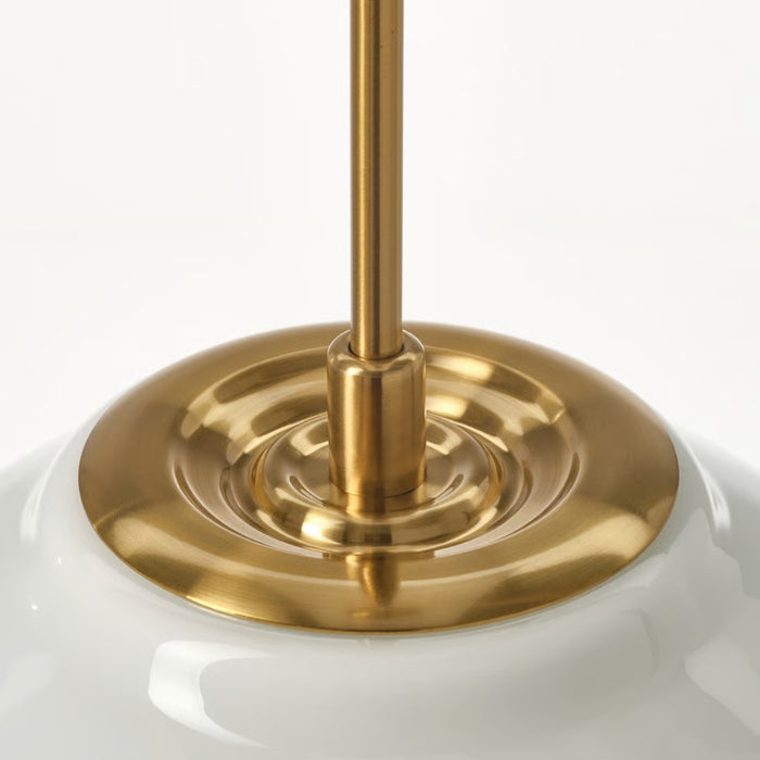 Close-up of a gold lampshade base on a white background