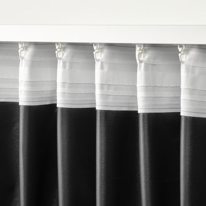 Black and white striped curtains with a plain background