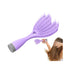 Purple hairbrush with gray handle held by a person on a white background