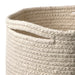 Close-up of a woven beige basket with a white background