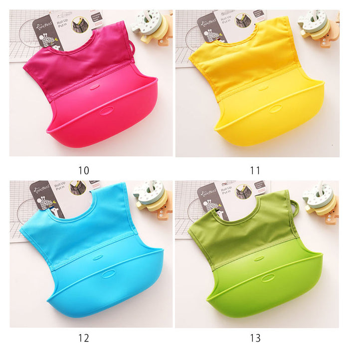 Four colorful baby bibs in pink, yellow, blue, and green on a white background.