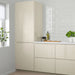 Beige kitchen cabinets with a white tiled wall and window in a modern kitchen setting.
