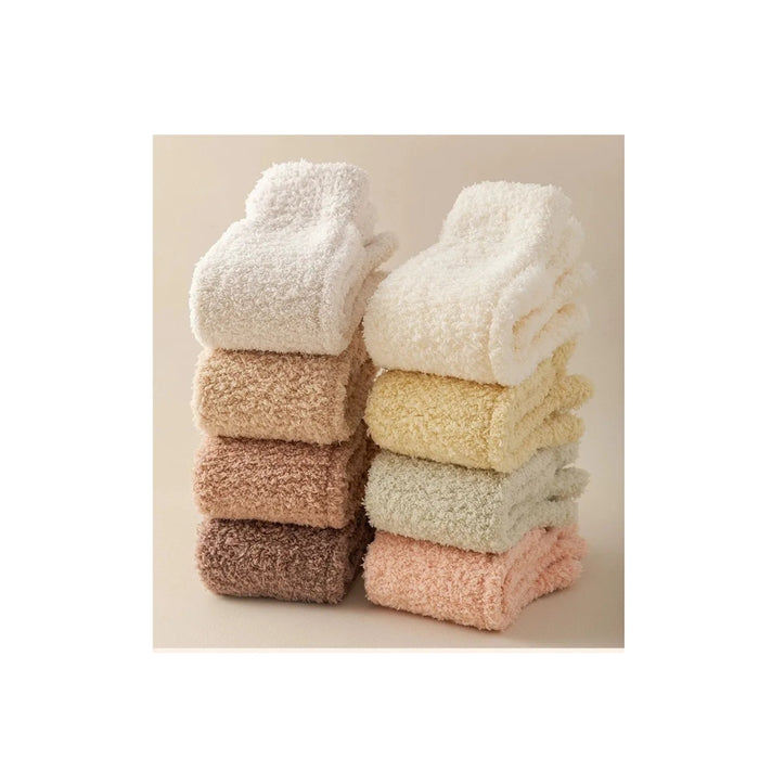 Stack of soft, textured socks in various colors on a neutral background