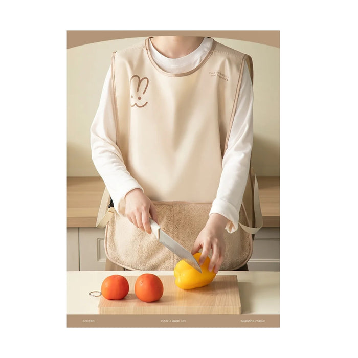 Person wearing a beige apron with a cartoon design, cutting a yellow fruit on a wooden cutting board.