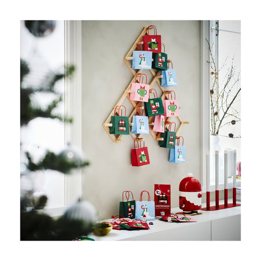 Wooden advent calendar with colorful bags on a wall
