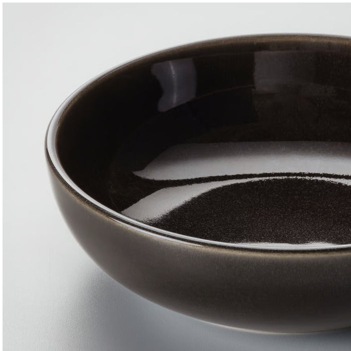 Close-up of GLADELIG dish with bubbling gratin, served alongside greens and bread in a warm, celebratory meal setup