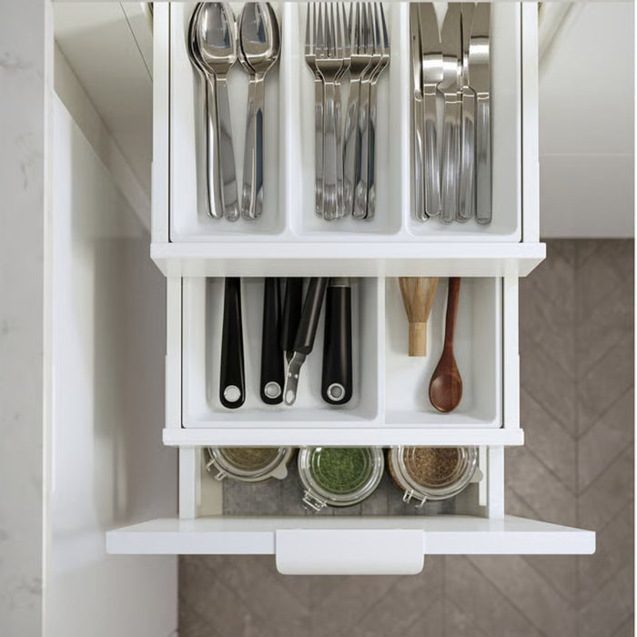 White kitchen drawer with cutlery and spices