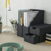 Black desk organizer with compartments on a desk with stationery items.