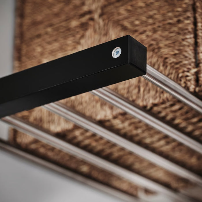 Black metal bracket attached to a wooden surface