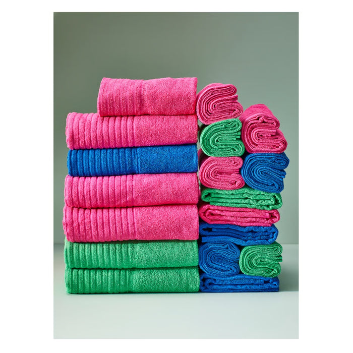 Stack of colorful towels in pink, blue, and green on a neutral background