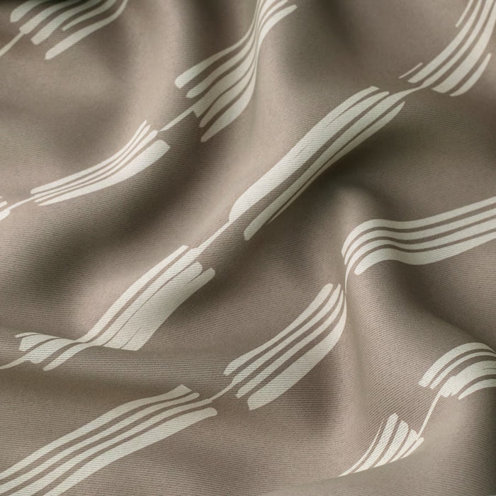  Fabric close-up of HÄCKBERBERIS curtains in taupe with white abstract wave pattern, emphasizing texture and softness
