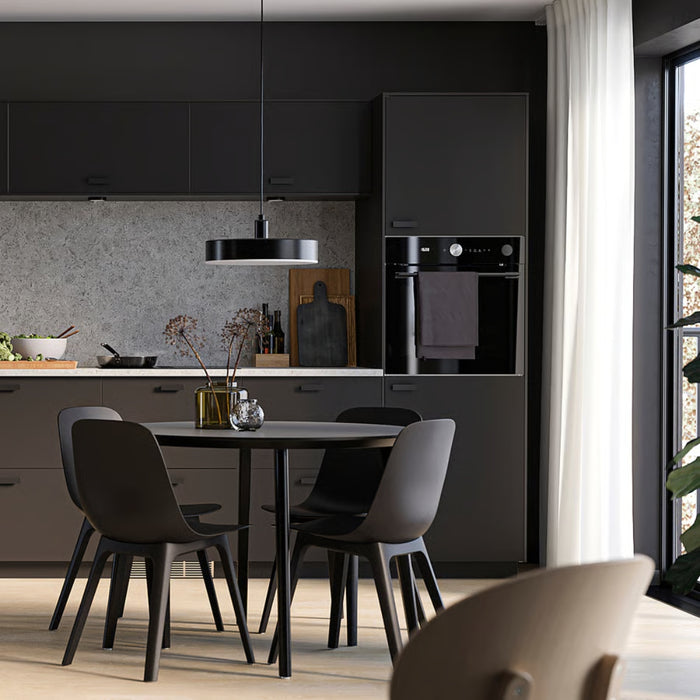 Minimalist kitchen and dining area with matte black cabinets and pendant light – 80537827