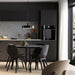 Minimalist kitchen and dining area with matte black cabinets and pendant light – 80537827