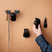 IKEA FRÖSÅDD black hooks on peach wall, moose hook holding necklace, hand adjusting horse hook