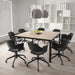 Modern office conference room with a wooden table and black chairs.