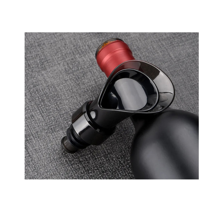 Close-up of a wine bottle with a red foil cap on a gray textured background