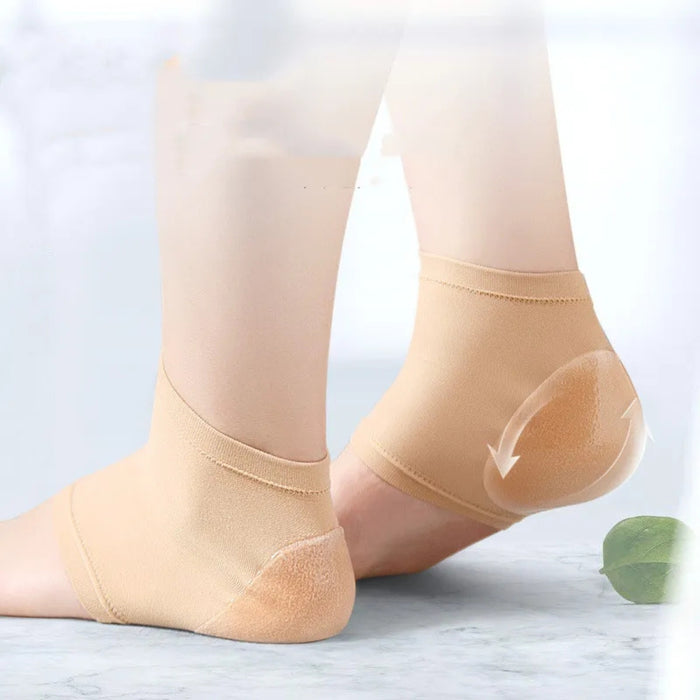 Beige compression socks being worn on a light background