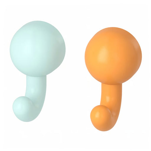 Orange HUMLESJÖN hook holding a cup with toothbrushes; turquoise hook holding a towel in a colorful bathroom.

