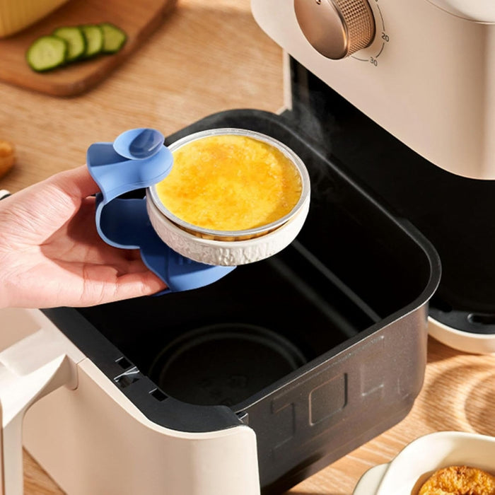 Blue heart-shaped silicone glove lifting hot bowl from air fryer; heat-resistant, secure grip for safe handling of cookware – 160000379026413641401