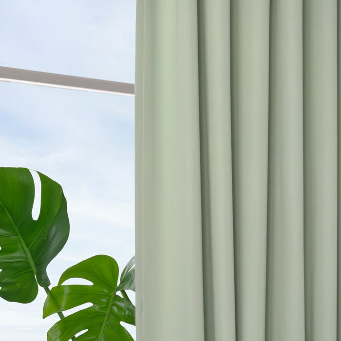 BENGTA block-out curtain, green, 210x250 cm. Pleated panel beside window with Monstera plant in foreground – soft fabric adds calm, natural vibe to room – 60602164.