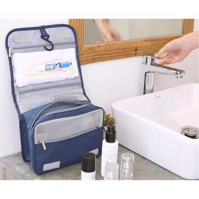 Travel storage waterproof bag, blue. Shown open on sink counter with towel, toothbrush, and essentials in mesh pockets – organized bathroom setup with clean, practical styling – 13403615.