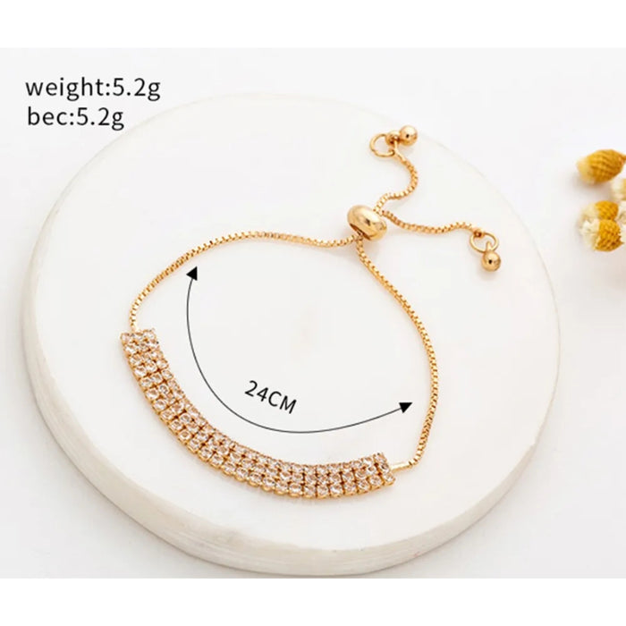 Gold bracelet with measurement details on a white background