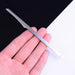 Digital Shoppy manicure spatula – hand holding micro rasp tool with textured surface for shaping nails
